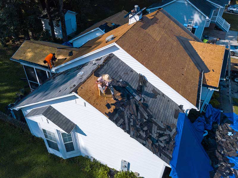 Workers replacing the roof of a residential home